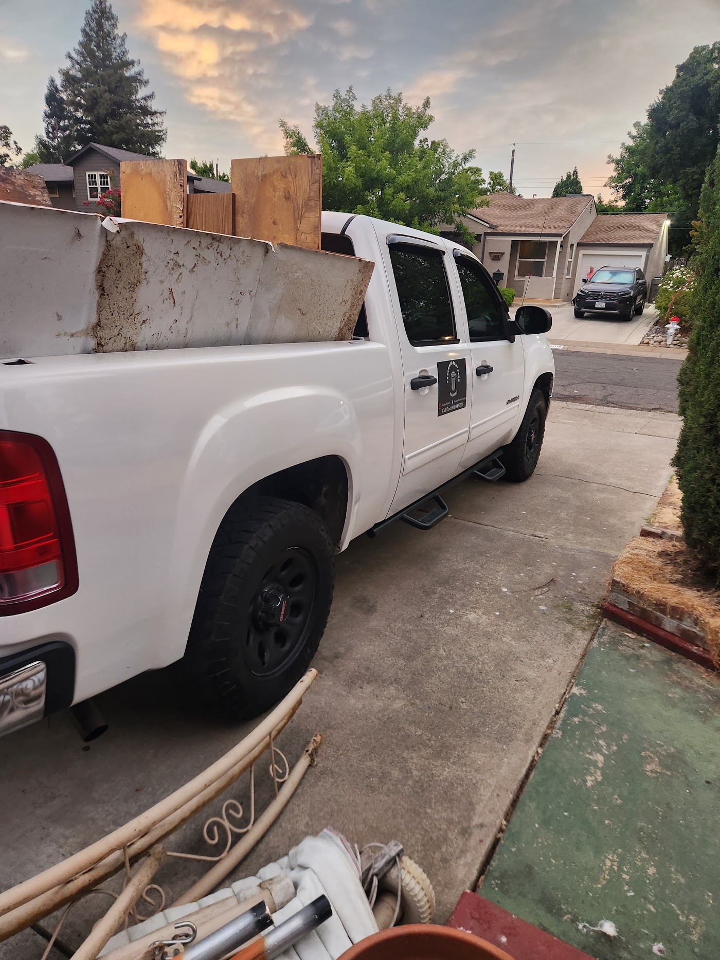 Truck loaded with scrap lumber and old cabinets on a street