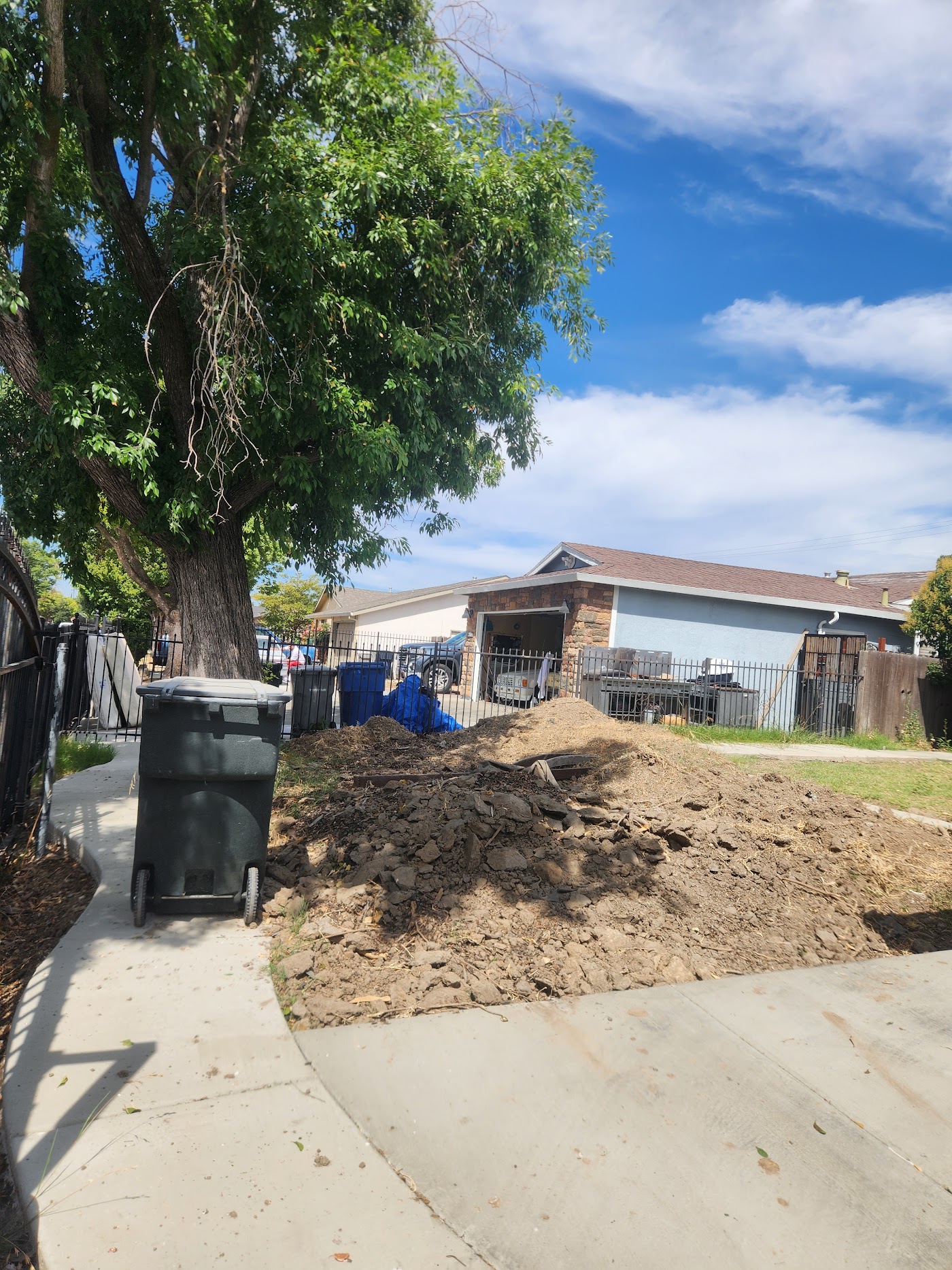 Driveway cleared of debris with fresh dirt graded