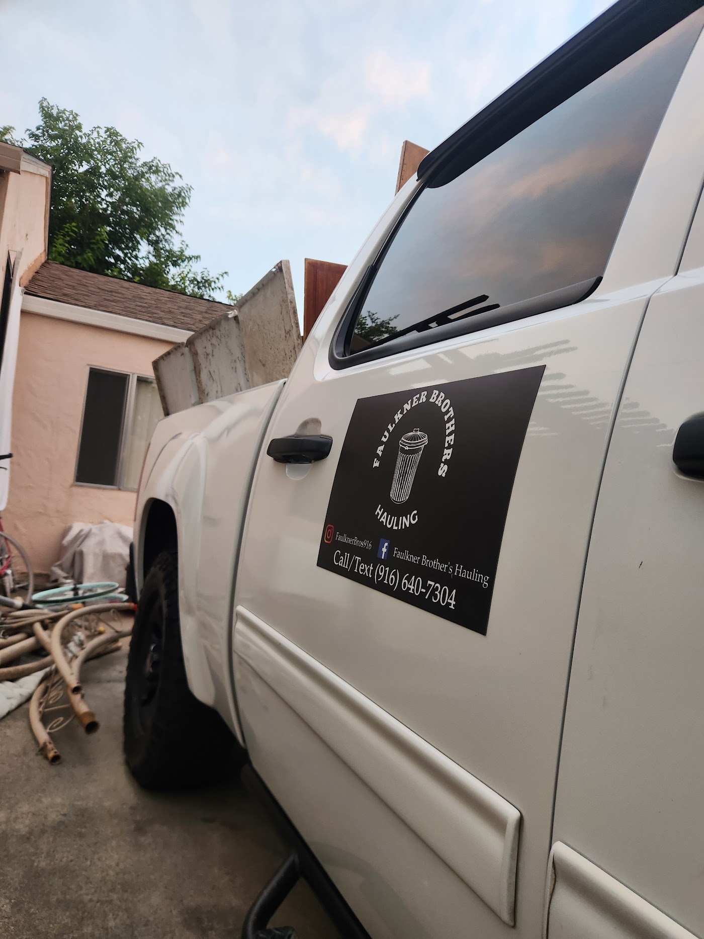 Faulkner Brothers truck parked next to a cleared fence line