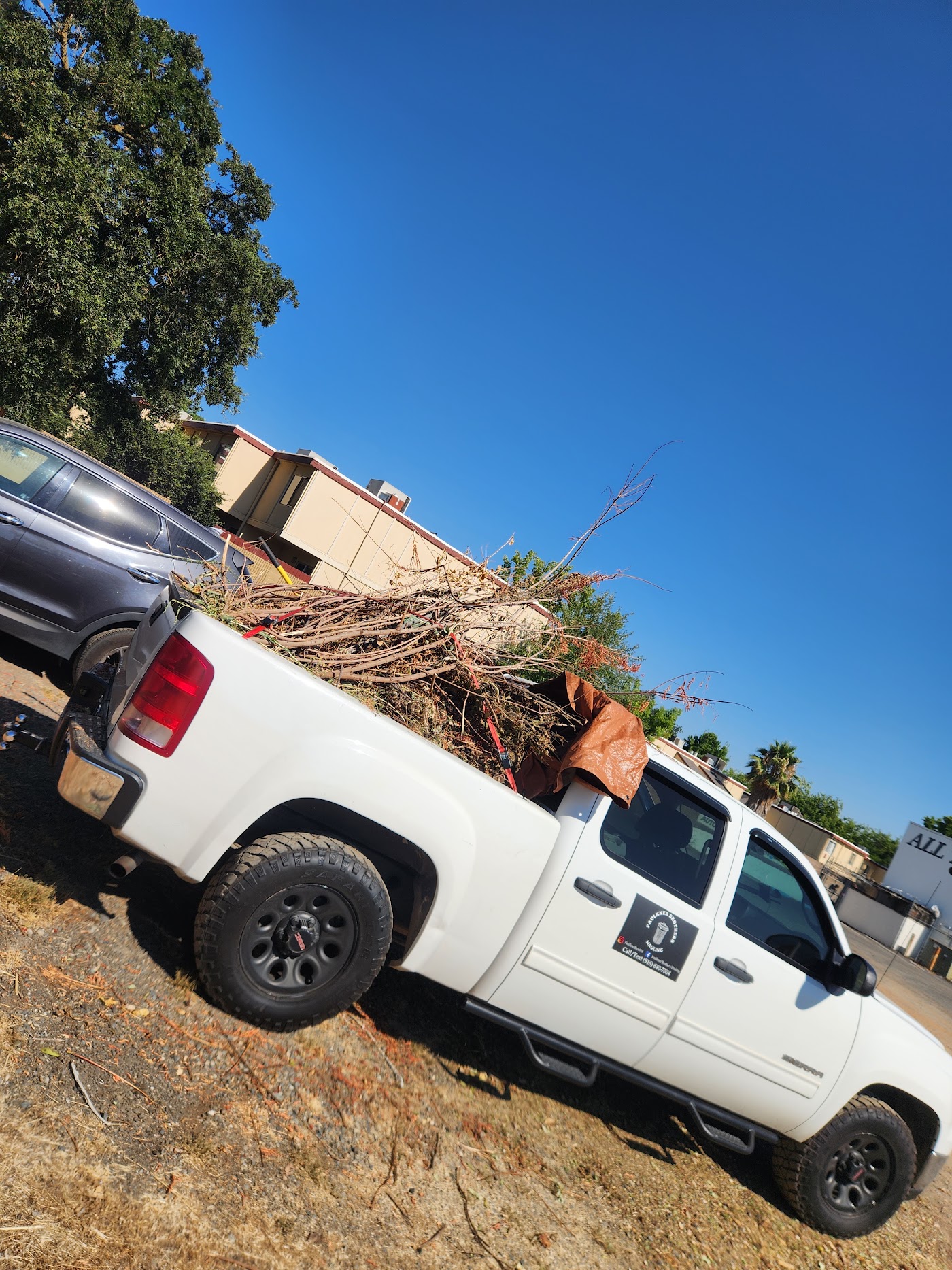 Dump trailer tipped up unloading soil at a job site